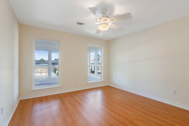 empty room featuring ceiling fan and light hardwood / wood-style flooring