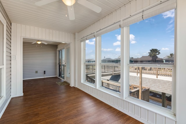 unfurnished sunroom with ceiling fan