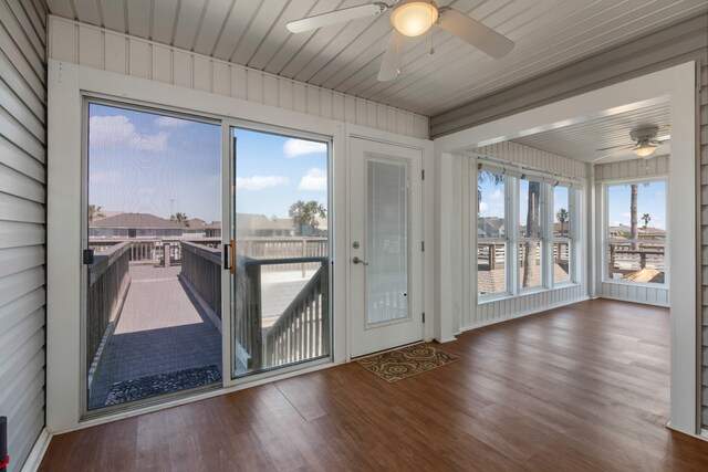 unfurnished sunroom with ceiling fan and wooden ceiling