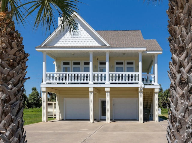 raised beach house with a balcony and a garage