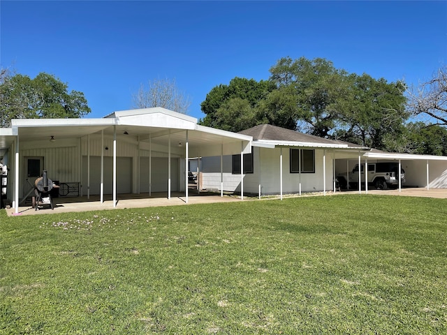 rear view of house with a yard and a carport