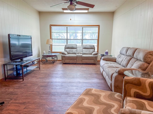 living room with dark hardwood / wood-style floors and ceiling fan