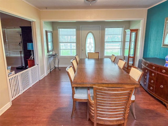 dining area with dark wood-type flooring and ornamental molding