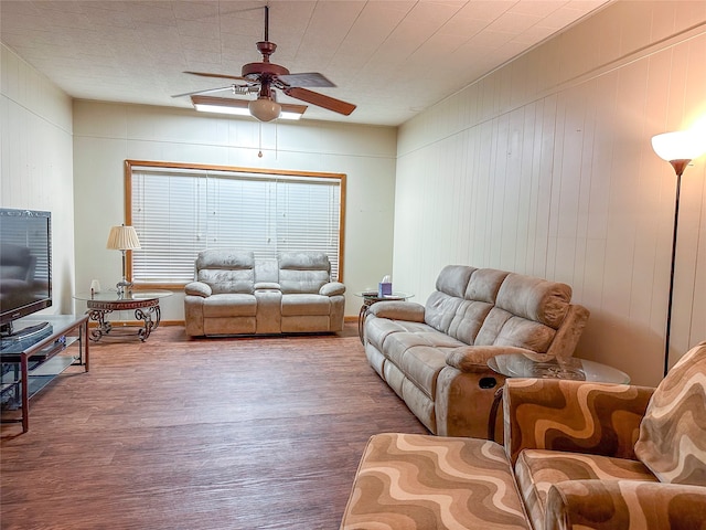 living room featuring ceiling fan and hardwood / wood-style flooring