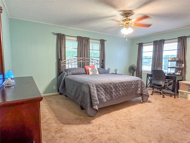 bedroom with ornamental molding, carpet floors, a textured ceiling, and ceiling fan