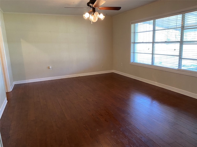 unfurnished room featuring ceiling fan, dark hardwood / wood-style floors, and crown molding