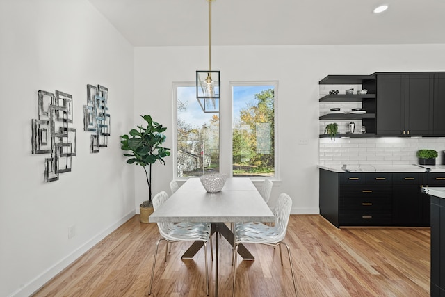 dining space featuring light hardwood / wood-style floors and an inviting chandelier