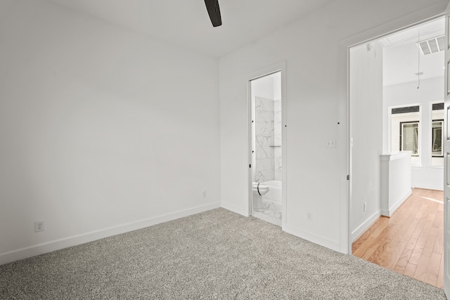 carpeted spare room with ceiling fan