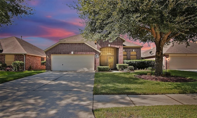 view of front of property with a yard and a garage