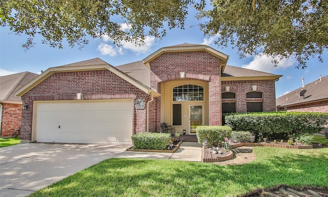 view of property featuring a front yard and a garage