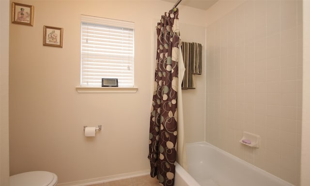 bathroom with shower / bath combo with shower curtain, tile patterned flooring, and toilet