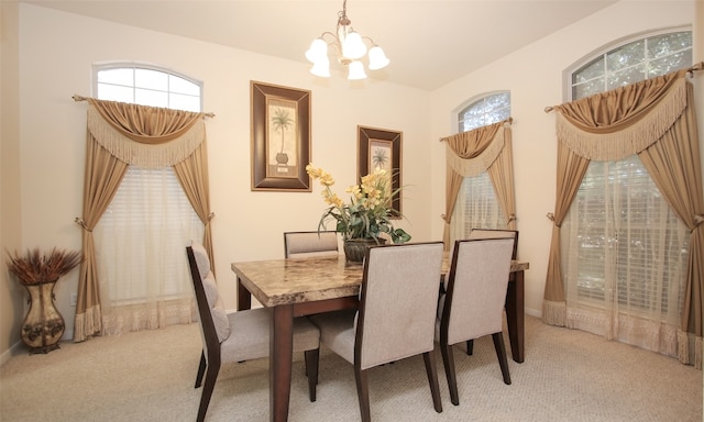 dining room featuring carpet and a chandelier