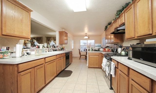 kitchen with kitchen peninsula, decorative backsplash, stainless steel appliances, sink, and light tile patterned flooring