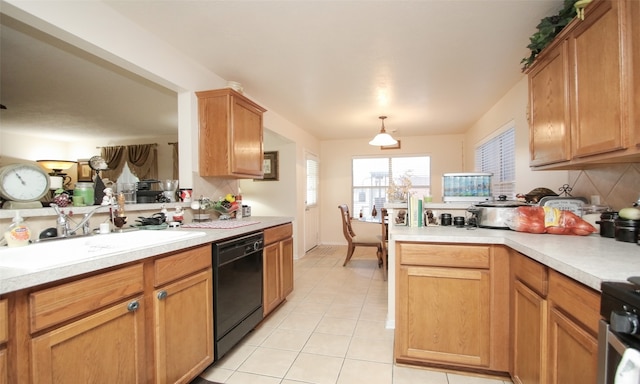 kitchen with sink, stainless steel stove, light tile patterned floors, black dishwasher, and decorative light fixtures