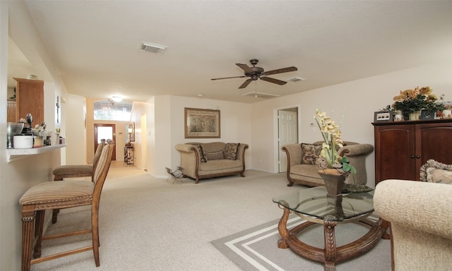 living room featuring light colored carpet and ceiling fan