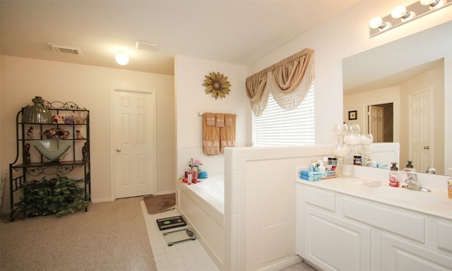 bathroom with a washtub and vanity