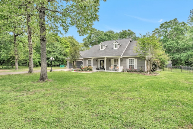 rear view of house with a lawn and a porch