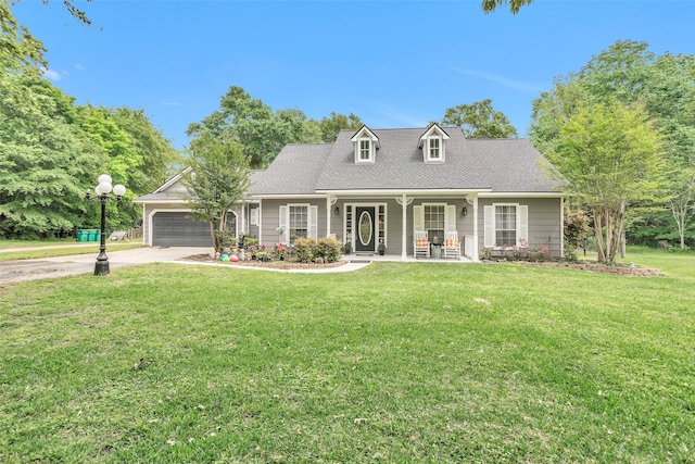 cape cod home with covered porch, a front lawn, and a garage