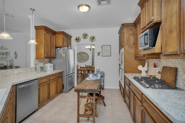 kitchen featuring an inviting chandelier, decorative light fixtures, backsplash, and stainless steel appliances