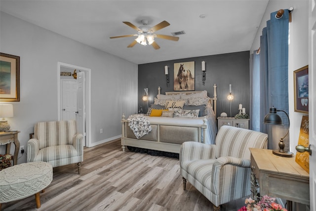 bedroom with ceiling fan and light hardwood / wood-style floors