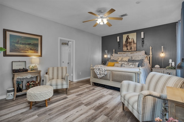 bedroom with ceiling fan and light hardwood / wood-style flooring