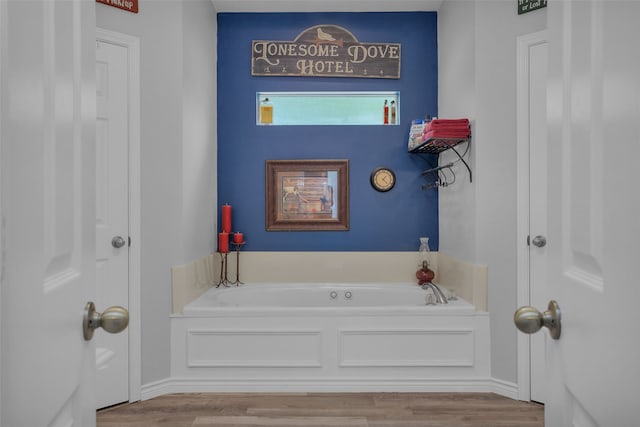 bathroom featuring a washtub and wood-type flooring