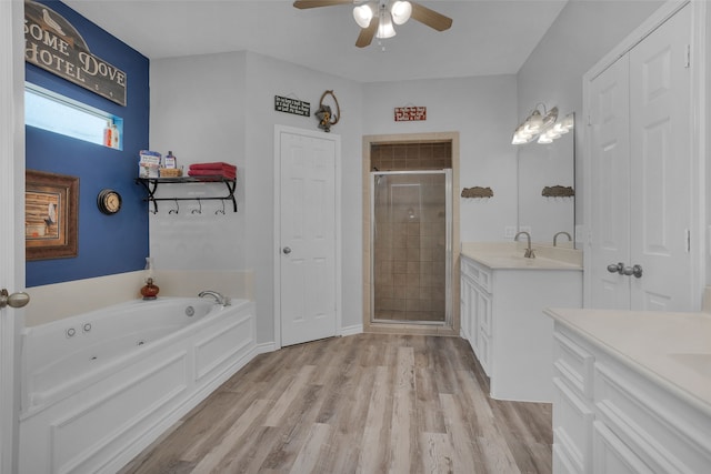 bathroom with vanity, plus walk in shower, ceiling fan, and hardwood / wood-style flooring