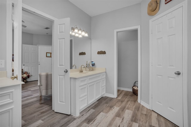 bathroom with vanity and wood-type flooring