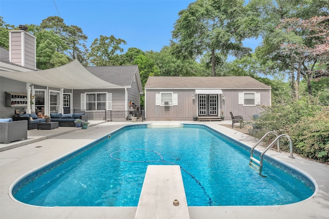 view of swimming pool with an outdoor hangout area, a patio, and a diving board