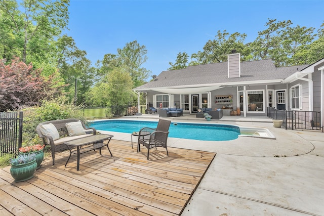 view of swimming pool with outdoor lounge area, a deck, and a patio area