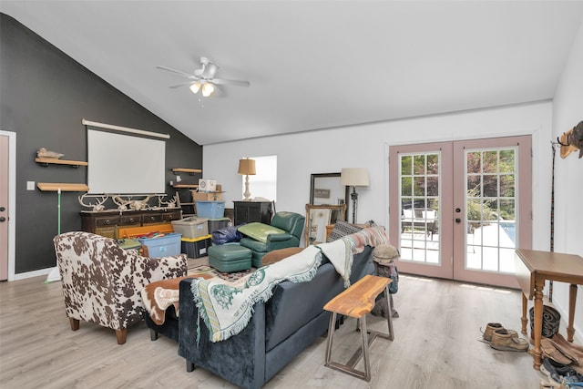 living room with french doors, light hardwood / wood-style floors, ceiling fan, and vaulted ceiling