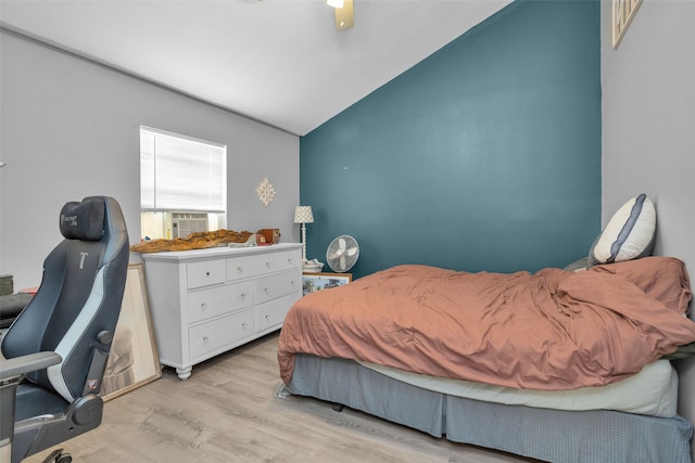 bedroom featuring ceiling fan, lofted ceiling, and light hardwood / wood-style flooring