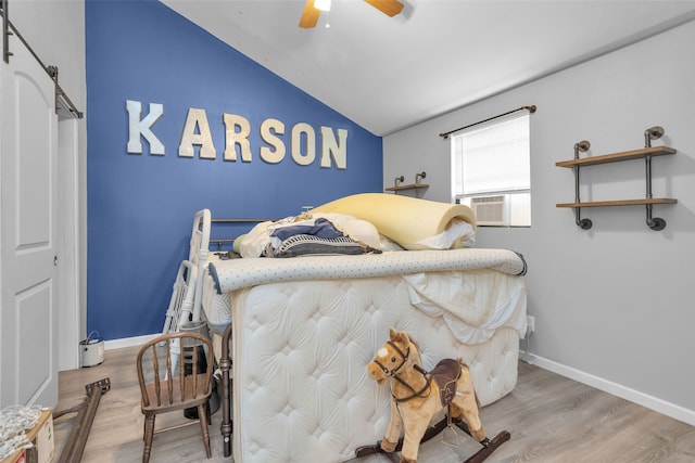 bedroom with lofted ceiling, ceiling fan, and light hardwood / wood-style flooring