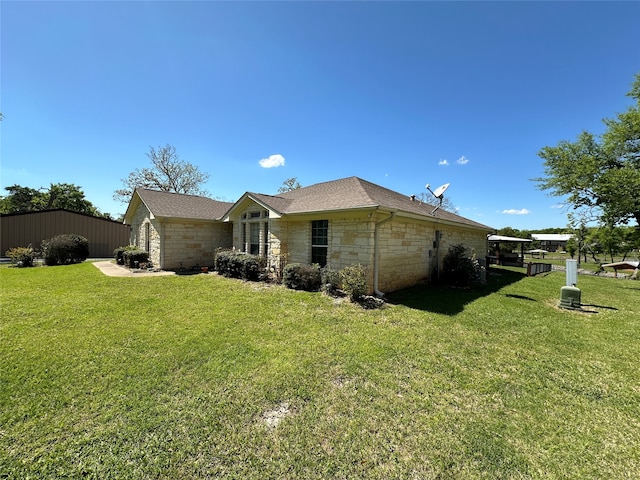 rear view of property featuring a lawn