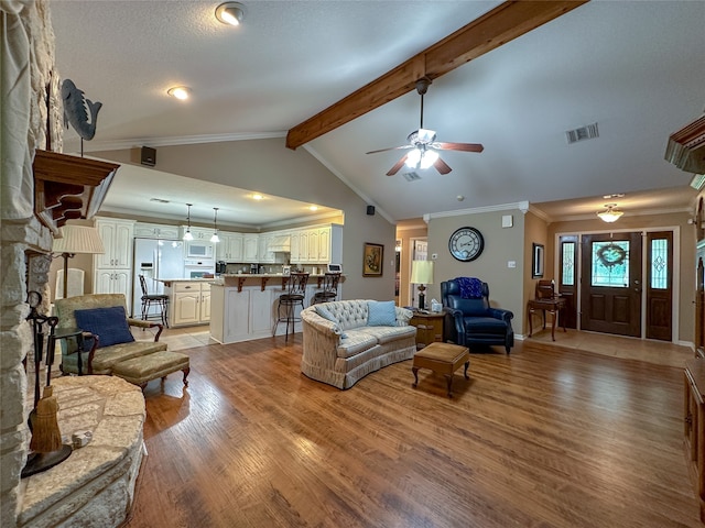 living room featuring ceiling fan, crown molding, beamed ceiling, light hardwood / wood-style floors, and high vaulted ceiling