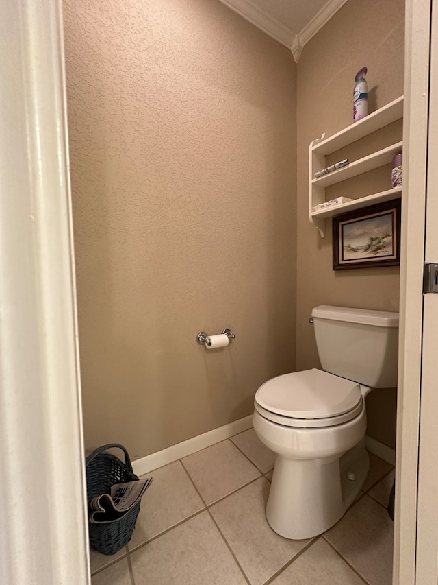 bathroom featuring toilet, ornamental molding, and tile floors