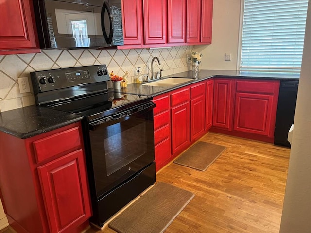 204 W Fayette St, Fayetteville, TX 78940 - kitchen with tasteful backsplash, sink, light hardwood / wood-style flooring, and black appliances