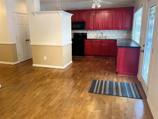204 W Fayette St, Fayetteville, TX 78940 - kitchen with sink, backsplash, hardwood / wood-style flooring, ceiling fan, and black appliances
