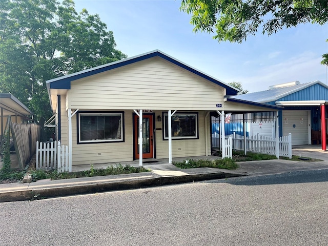 bungalow-style home with a garage and covered porch