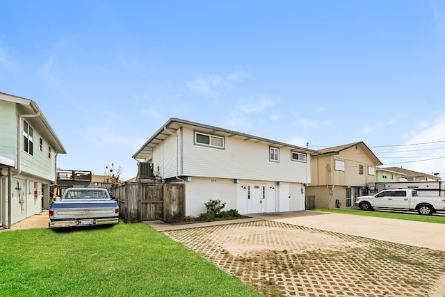 exterior space with a yard and central AC unit