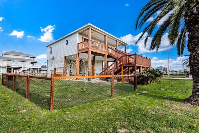 back of property featuring a deck and a lawn