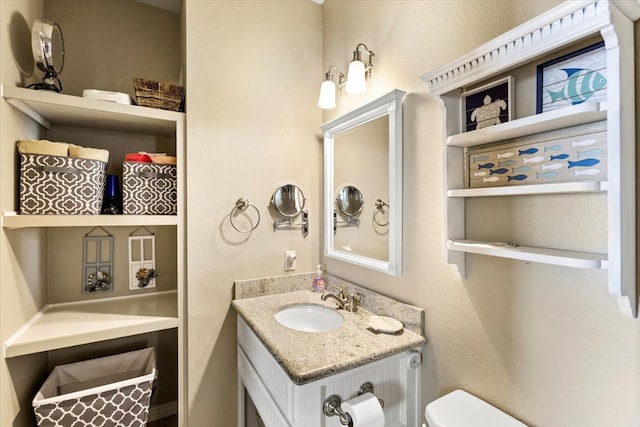 bathroom featuring toilet and vanity