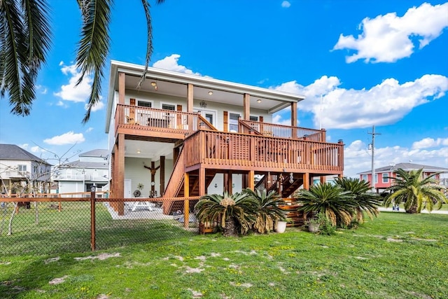 rear view of property featuring a deck and a yard