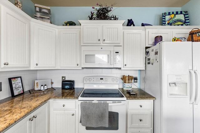 kitchen featuring tasteful backsplash, dark stone countertops, white appliances, and white cabinetry