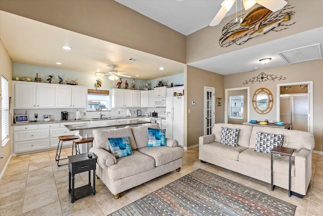 tiled living room with ceiling fan