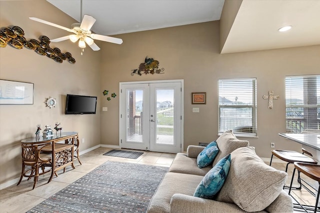 living room with ceiling fan, high vaulted ceiling, light tile flooring, and french doors