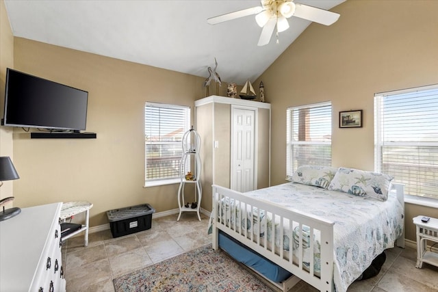 tiled bedroom featuring high vaulted ceiling, a closet, ceiling fan, and multiple windows