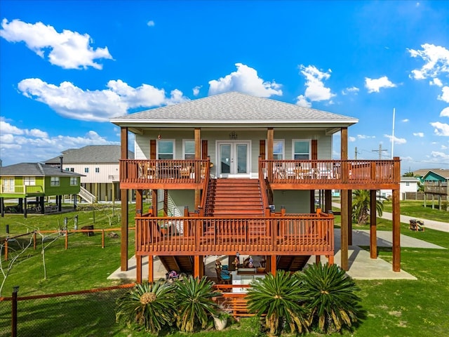 back of house featuring a wooden deck and a yard