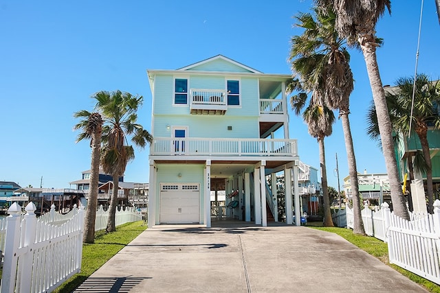 beach home featuring a balcony and a garage