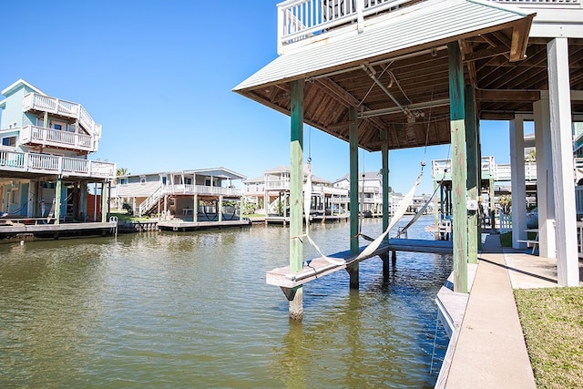 dock area featuring a balcony and a water view